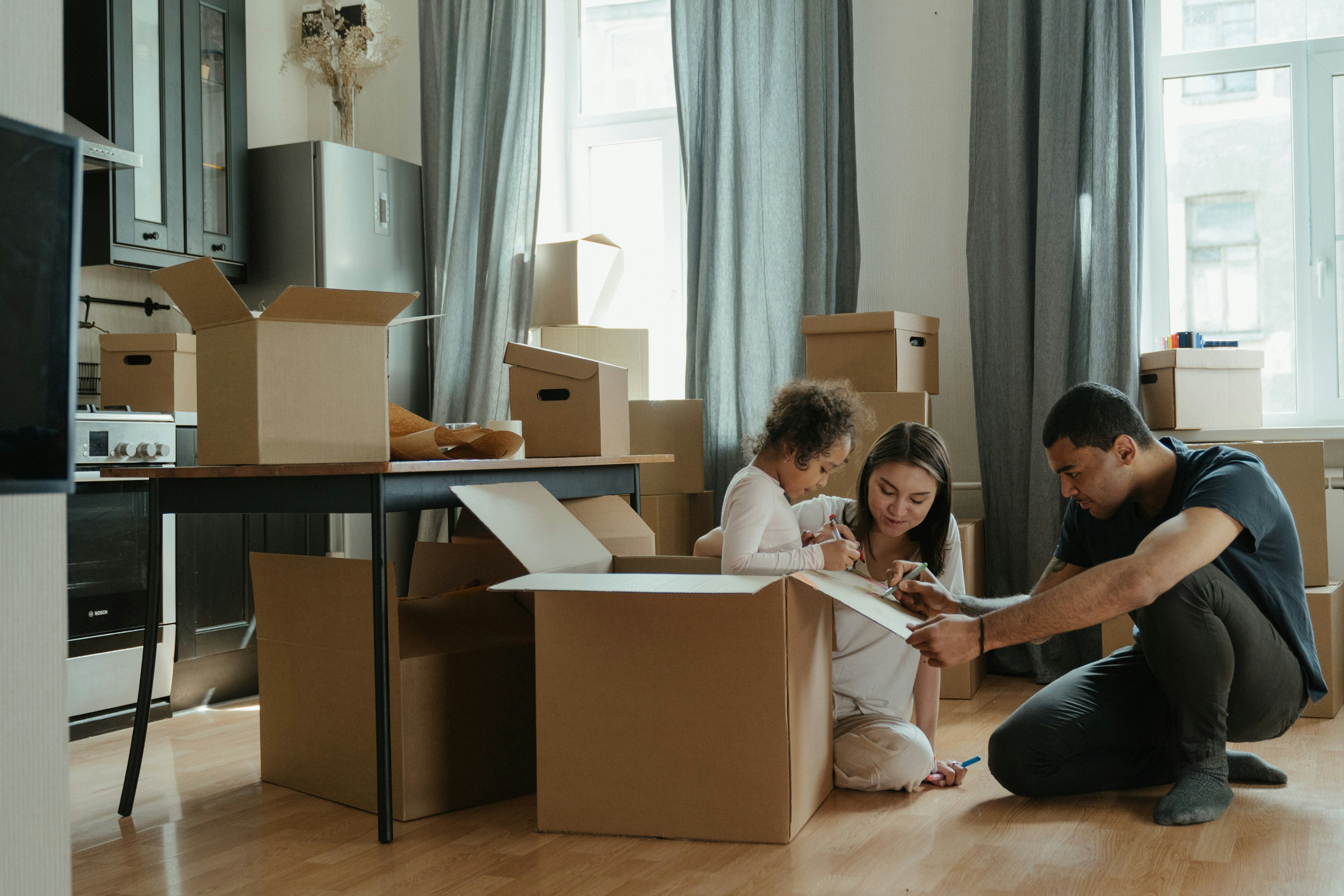 Family unpacking after buying their first home
